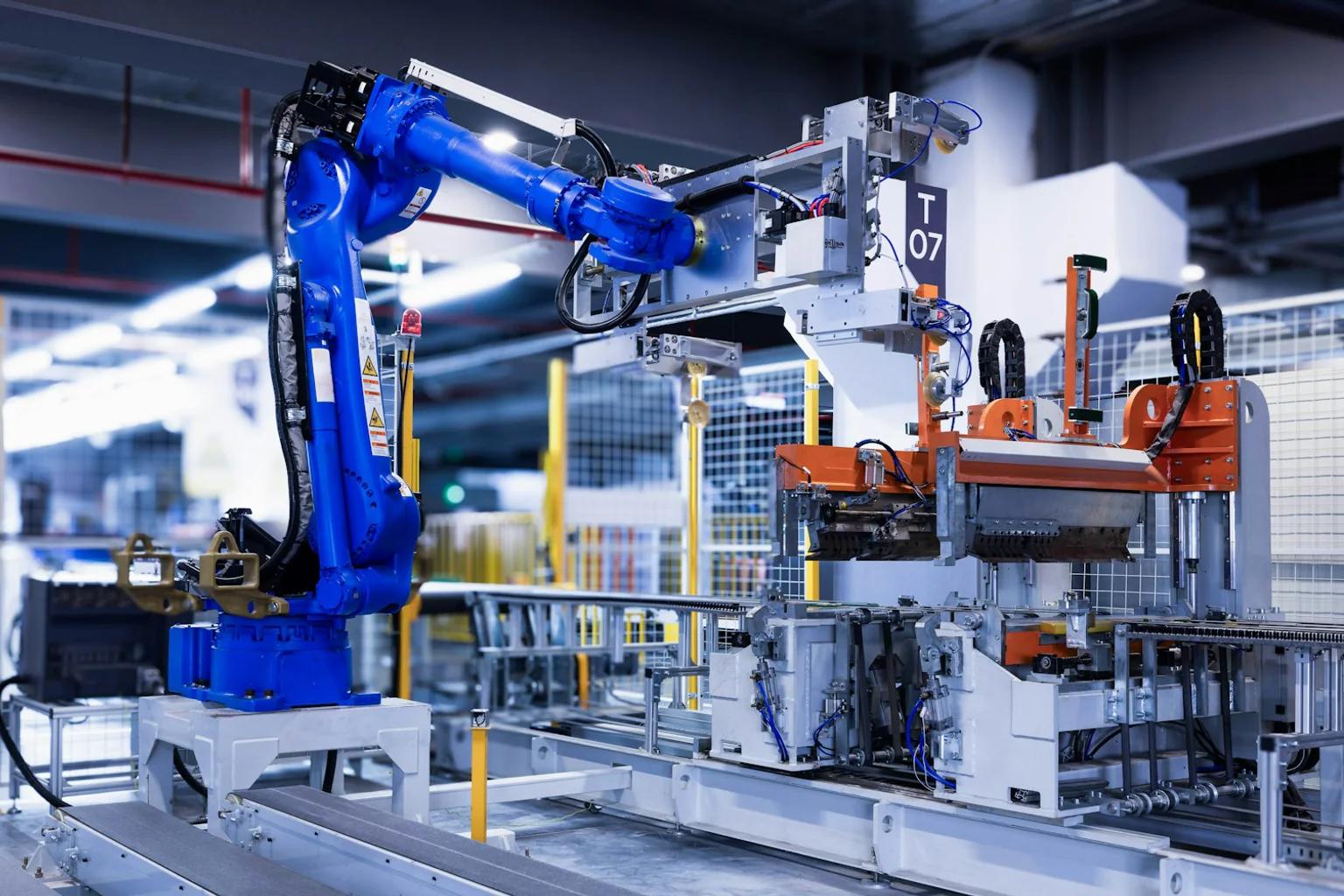 Blue industrial robot serving an automated production cell